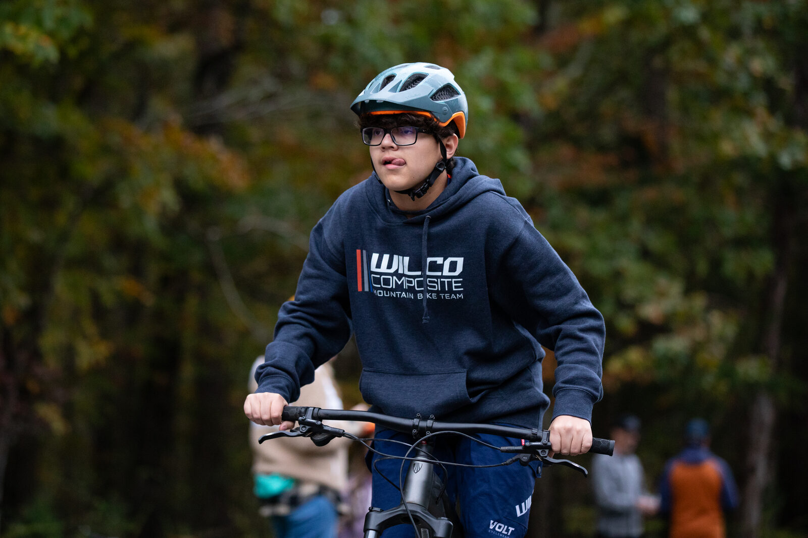 A smiling Wilco rider in a team hoodie at the race venue