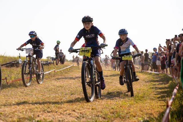Three riders sprinting for the hole shot